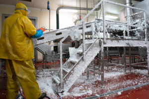 man spraying equipment with foaming product